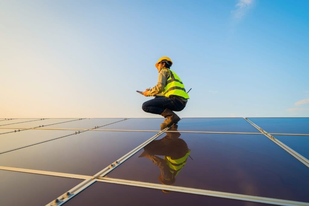 Sustainability solar panels with worker